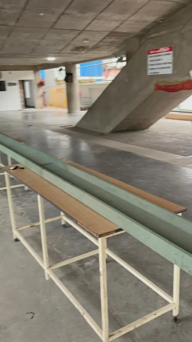A long wooden test channel laid on tables in the school hall