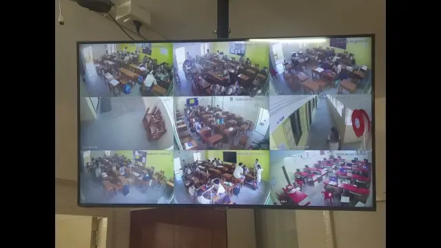 A screen showing a grid of classroom CCTV feeds with detections